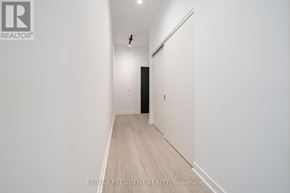 Toronto (Moss Park) condo for rent - A long, narrow hallway with a door at the end.