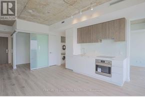 Toronto (Mount Pleasant West) condo for rent - A modern kitchen with a stove top oven and a washer and dryer built into the cabinetry.