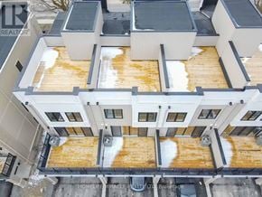 Clarington (Bowmanville) townhouse for rent - A building with a roof covered in snow.