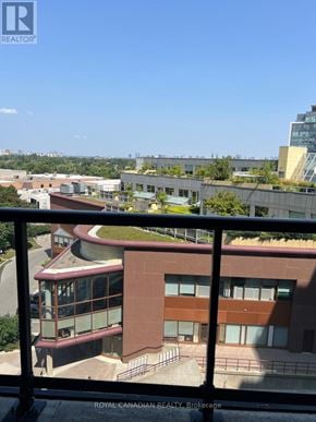 Toronto (York University Heights) condo for rent - A building with a red roof and a balcony with a metal railing.