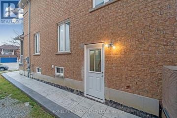 Brampton (Sandringham-Wellington) apartment for rent - A brick building with a white door and windows.