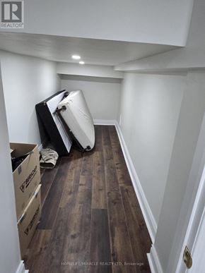 Brampton (Sandringham-Wellington) apartment for rent - A hallway with boxes on the floor and a white wall.
