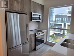 Mississauga (Hurontario) condo for rent - A modern kitchen with stainless steel appliances and a view of a cityscape.