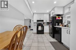 Kitchener apartment for rent - A modern kitchen with black appliances and white cabinets.