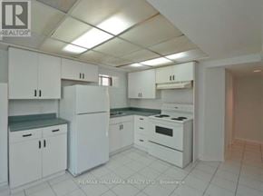 Pickering (Liverpool) apartment for rent - A white kitchen with a refrigerator, oven, and cabinets.