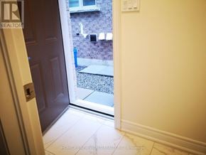Markham (Cedarwood) apartment for rent - A doorway leading to a backyard with a brick wall.