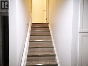 Markham (Cedarwood) apartment for rent - A staircase with wooden steps leading up to a door.