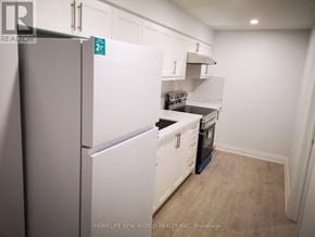 Markham (Cedarwood) apartment for rent - A small kitchen with white appliances and cabinets.