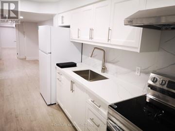 Markham (Cedarwood) apartment for rent - A white kitchen with a stove and refrigerator.