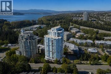 Port Moody apartment for rent - A realtor logo is on a picture of a cityscape.
