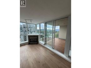 Port Moody apartment for rent - A living room with a fireplace and sliding glass doors.