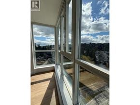 Port Moody apartment for rent - A realtor logo is on a window.