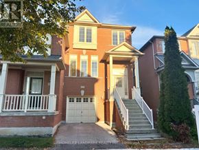 Markham (Berczy) apartment for rent - A two-story brick house with a garage and a front porch.