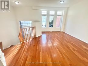 Markham (Berczy) apartment for rent - A room with wooden flooring and a staircase.