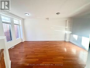 Markham (Berczy) apartment for rent - A room with wooden flooring and white walls.