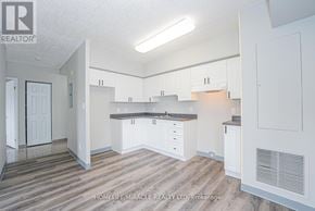Waterloo multi-family for rent - A real estate listing photo of a kitchen and living room.