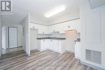 Waterloo multi-family for rent - A real estate listing photo of a kitchen and living room.
