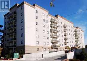 Waterloo multi-family for rent - A large white apartment building with balconies and a sign that reads "HOMELIFE Miracle BROKERAGE LTD.".