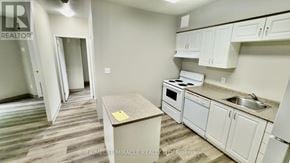 Waterloo multi-family for rent - A kitchen area with a table and a sink.
