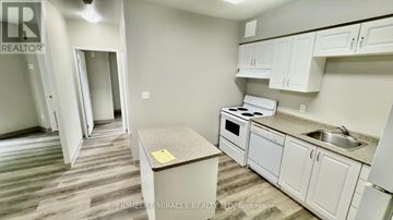 Waterloo multi-family for rent - A kitchen area with a table and a sink.