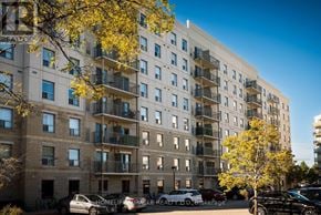 Waterloo multi-family for rent - A building with balconies and cars parked in front.