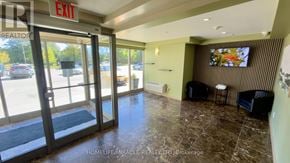 Waterloo multi-family for rent - A lobby with a large exit sign and a flat screen TV mounted on the wall.