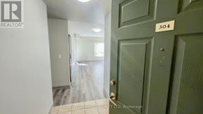 Waterloo multi-family for rent - A realtor photo of a room with a door labeled 304.