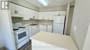 Waterloo multi-family for rent - A kitchen with white appliances and cabinets.