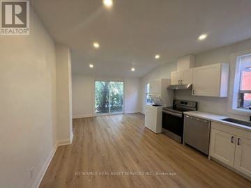 Toronto (Kensington-Chinatown) apartment for rent - A kitchen with white cabinets and a wooden floor.