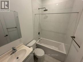Toronto (Kensington-Chinatown) apartment for rent - A white bathroom with a toilet, sink, and bathtub.