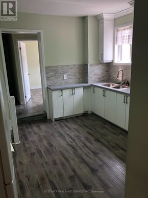 Toronto (Annex) apartment for rent - A kitchen with white cabinets and a stone backsplash.