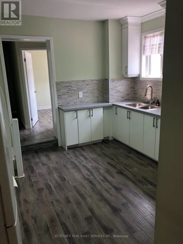Toronto (Annex) apartment for rent - A kitchen with white cabinets and a stone backsplash.