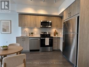 Toronto (Humber Heights) condo for rent - A modern kitchen with stainless steel appliances and wooden cabinets.