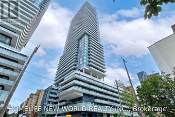 Toronto (Mount Pleasant West) condo for rent - A tall building with many windows is the focal point of the image.