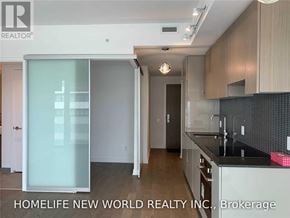 Toronto (Mount Pleasant West) condo for rent - A modern kitchen with a glass door and wooden cabinets.