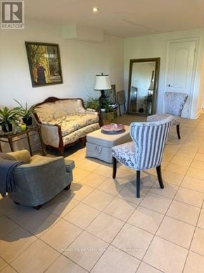 Vaughan (Patterson) apartment for rent - A living room with a couch, chair, and lamp.
