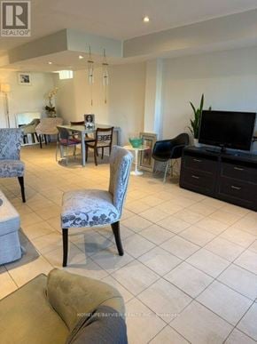 Vaughan (Patterson) apartment for rent - A living room with a television, chairs, and a dining table.