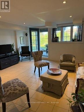 Vaughan (Patterson) apartment for rent - A living room with a television, two chairs, and a coffee table.