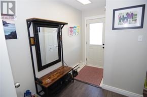 St. John's apartment for rent - A hallway with a mirror and a framed picture on the wall.