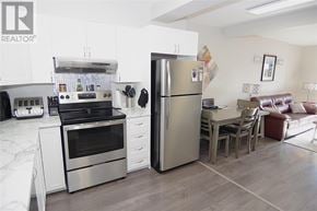 St. John's apartment for rent - A modern kitchen with a refrigerator, oven, and dining area.