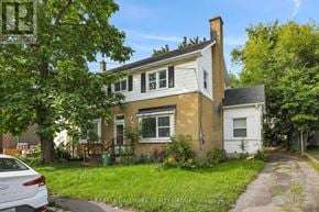 Ottawa duplex for rent - A house with a white car parked in front of it.