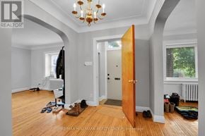 Ottawa duplex for rent - A room with a wooden floor and a chandelier.