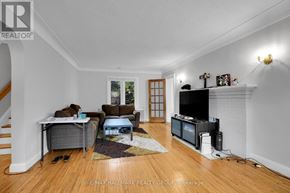 Ottawa duplex for rent - A living room with a couch, chair, and television.
