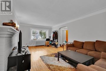 Ottawa duplex for rent - A living room with a brown couch and a black television.