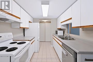 London North (North G) condo for rent - A white stove top oven with a white refrigerator in a kitchen.
