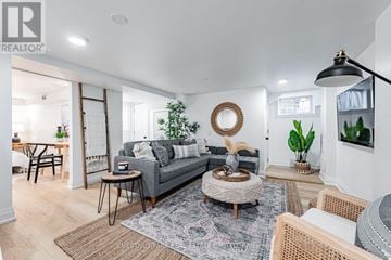 Toronto (East End-Danforth) apartment for rent - A living room with a grey sofa, a round coffee table, and a rug with a pattern.