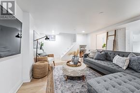 Toronto (East End-Danforth) apartment for rent - A living room with a grey couch and a wooden coffee table.