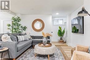 Toronto (East End-Danforth) apartment for rent - A living room with a grey couch, a round woven coffee table, and a large round mirror on the wall.