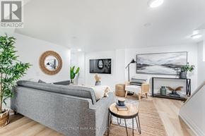Toronto (East End-Danforth) apartment for rent - A living room with a grey couch, a coffee table, and a painting on the wall.