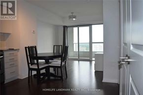 Toronto (Henry Farm) condo for rent - A black chair sits in a white room with a sliding glass door.